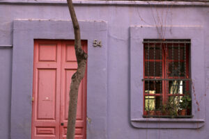 A facade of a house in Barcelona with violet colored walls. - MyVideoimage.com