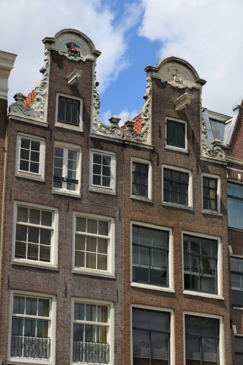 Amsterdam buildings facade. Detail of facades of typical buildings with hooks for lifting go - MyVideoimage.com | Foto stock & Video footage