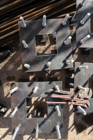 Anchor plates. Construction site for a building with a steel structure. Plates with anchor bolts for mounting steel columns on a reinforced concrete foundation. - MyVideoimage.com | Foto stock & Video footage