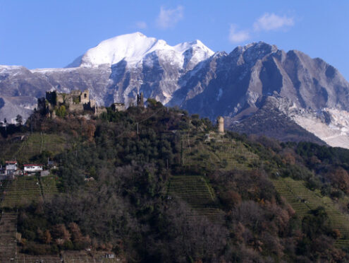 Carrara panorama. Ancient castle of Moneta located on a hill near the city of Carrara. In the background, Monte Sagro and the Apuan Alps.