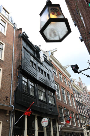 Ancient house with dark wood facade in the city center. In the f - MyVideoimage.com