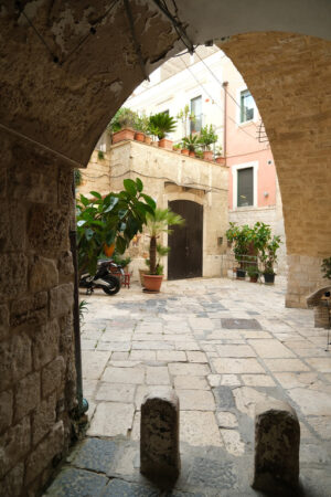 Ancient houses in the alleys of the city of Bari. Ogival vault in an alley. Marble flooring. - MyVideoimage.com