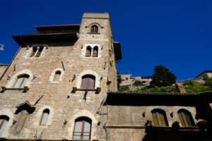 Ancient palace with stone wall and windows bordered in light marble. Gothic style. - MyVideoimage.com