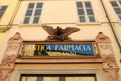 Ancient sign of a pharmacy shop dominated by a sculpture depicting an eagle. - MyVideoimage.com