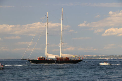 Ancient wooden sailboat in the middle of the sea. In the backgro - MyVideoimage.com