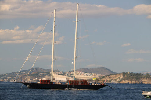 Ancient wooden sailboat in the middle of the sea. In the backgro - MyVideoimage.com