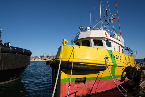 Anti-pollution vessel TAGIS of Castalia anchored at the port of La Spezia. Painted hull of various colors: Yellow, green, red. - MyVideoimage.com