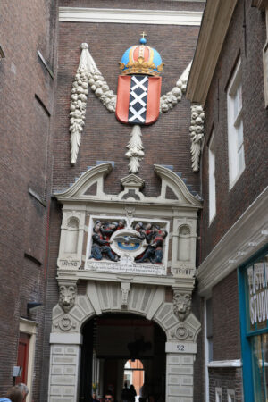 Arched door in ancient red brick building. Coat of arms of the c - MyVideoimage.com