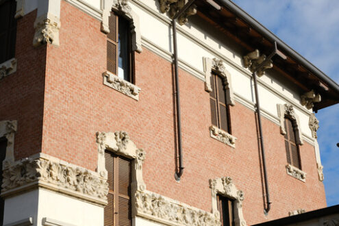 Art Nouveau building in the city of Busto Arsizio. Brick facade and floral decorations. - MyVideoimage.com