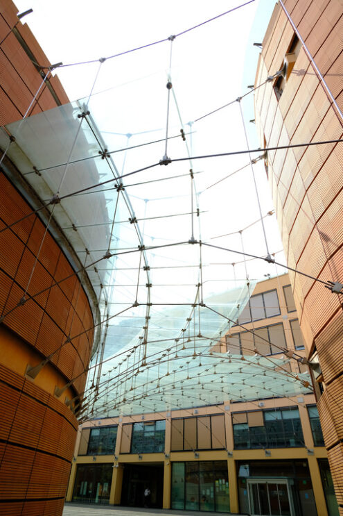 Banco BPM. Modern building with glass roof and brick facade. Foto stock royalty free. - MyVideoimage.com | Foto stock & Video footage