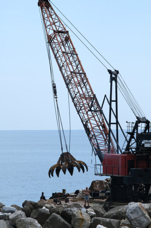 Barge with crane for dredging the seabed at the port of Riomaggiore, Cinque Terre, royalty free - MyVideoimage.com | Foto stock & Video footage