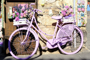 Bicycle painted purple with flowers in a souvenir shop in Assisi. - MyVideoimage.com