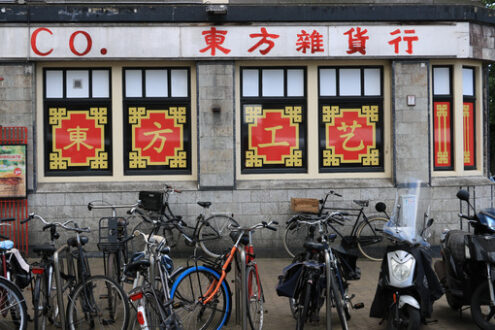 Bicycle parking in front of a shop with Chinese writing. - MyVideoimage.com