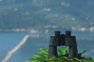 Binoculars on a table. Ligurian Mediterranean sea in the Gulf of La Spezia. - MyVideoimage.com | Foto stock & Video footage