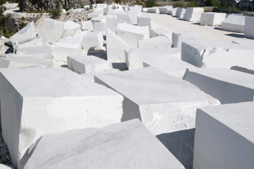 Blocks of white Carrara marble deposited in a square near the quarries. - MyVideoimage.com | Foto stock & Video footage