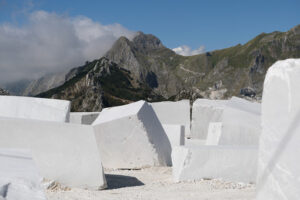 Blocks of white Carrara marble deposited in a square near the quarries. - MyVideoimage.com | Foto stock & Video footage