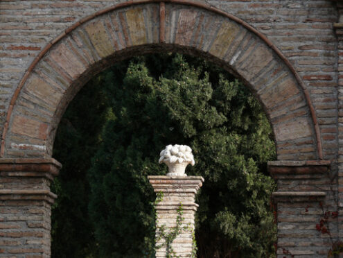 Brick arch and white marble sculpture - MyVideoimage.com