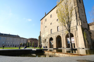 Buildings of the Pilotta in Parma. Fountain with pond and poplar trees. - MyVideoimage.com