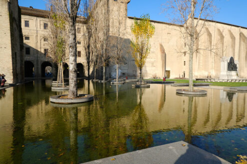 Buildings of the Pilotta in Parma. Fountain with pond and poplar trees. - MyVideoimage.com