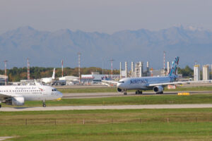 Bulgaria Air Airbus A320-214  airplane on the Malpensa airport runway. In the background the buildings of Terminal 1 and other airplanes. - MyVideoimage.com