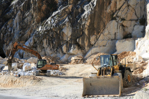 Bulldozer in a marble quarry. Excavator and a bulldozer in a Carrara marble quarry. Cave di marmo. - MyVideoimage.com | Foto stock & Video footage