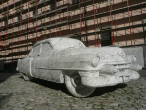 Cadillac sculpted in marble.  Sculpture depicting a Cadillac car made of white Carrara marble displayed in a town square. - MyVideoimage.com | Foto stock & Video footage