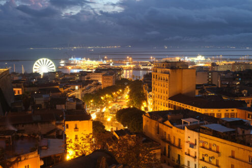 Cagliari by night. Panorama of Cagliari with ferry and ferris wheel. Stock photos. - MyVideoimage.com | Foto stock & Video footage