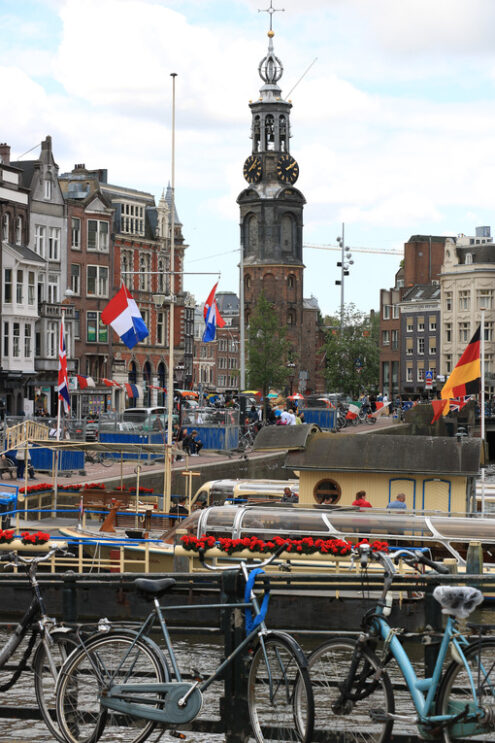 Canal boats. In the background a bell tower in the city center. - MyVideoimage.com