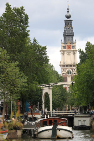 Canal boats. In the background a bell tower in the city center. - MyVideoimage.com