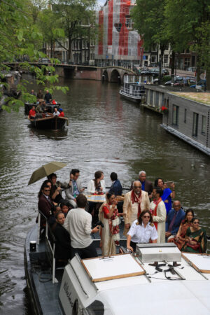 Canal party. A family celebrates on the boat in the city center. - MyVideoimage.com