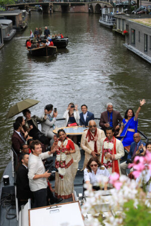 Canal party. A family celebrates on the boat in the city center. - MyVideoimage.com