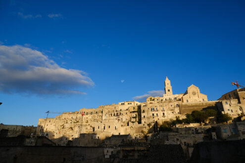 Case di Matera. Houses, church and bell tower in the city of Matera in Italy. The tuff blocks are the material used for the construction of the houses. - MyVideoimage.com | Foto stock & Video footage