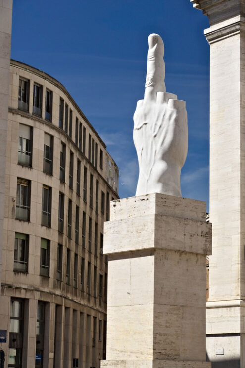 Cattelan’s finger. Sculpture of Cattelan’s finger in front of the Milan Stock Exchange. The Milan Stock Exchange building in Piazza Affari with the work of Maurizio Cattelan. - MyVideoimage.com | Foto stock & Video footage