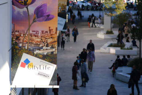 Centro commerciale Citylife a Milano. People strolling at the Citylife shopping center in Milan. Advertising sign of shops. - MyVideoimage.com | Foto stock & Video footage