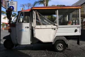 Characteristic taxi with motorcycle Ape parked on a street in Is - MyVideoimage.com