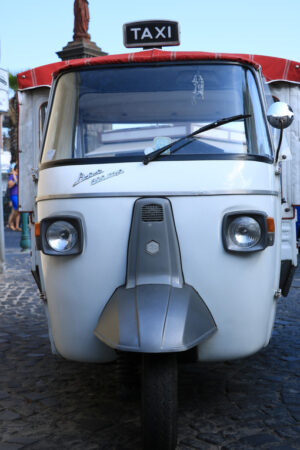 Characteristic taxi with motorcycle Ape parked on a street in Ischia. - MyVideoimage.com