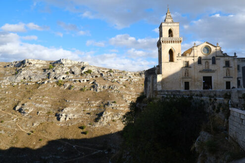 Chiesa a Matera. Church of San Pietro Caveoso in Matera. In the background the Mountains with ancient prehistoric caves. - MyVideoimage.com | Foto stock & Video footage