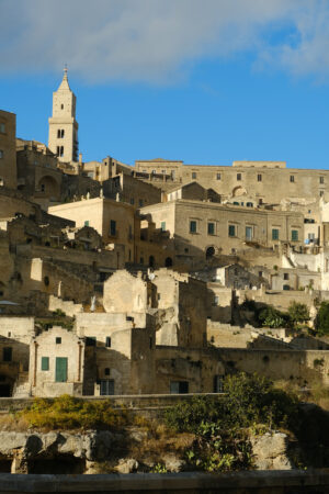 Città del sud Italia. Matera. Panorama of the Sassi of Matera with houses in tuff stone. Church and bell tower at dawn with sky and clouds. - MyVideoimage.com | Foto stock & Video footage