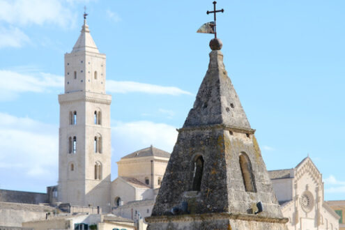 Città di Matera. Point of two bell towers and church in the ancient city of Matera in Italy. Construction with blocks of tufa stone. - MyVideoimage.com | Foto stock & Video footage