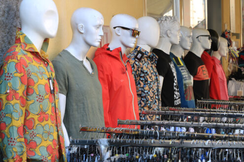 Clothing store mannequins with colorful shirts and dresses. - MyVideoimage.com