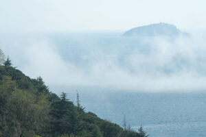 Clouds over the sea. Low clouds over the Mediterranean sea with fog. Background with Tino island. - MyVideoimage.com | Foto stock & Video footage