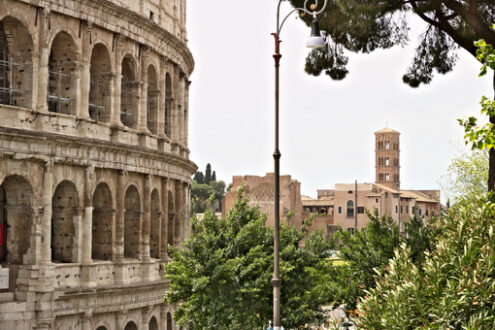 Coliseum Amphitheater. Rome. In the foreground an external wall of the Colosseum and in the background the Imperial Forums. The area is a huge open-air museum. Roma foto. - MyVideoimage.com | Foto stock & Video footage