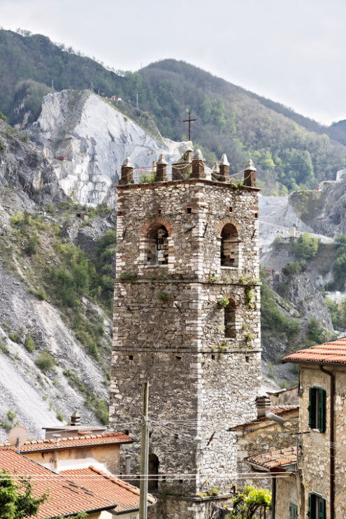 Colonnata Italy. Bell tower. Bell tower of the church built with white marble pebbles.   Colonnata, Carrara, Tuscany, Italy. - MyVideoimage.com | Foto stock & Video footage