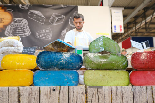 Colorful French cheeses in a stand at the craft fair. - MyVideoimage.com