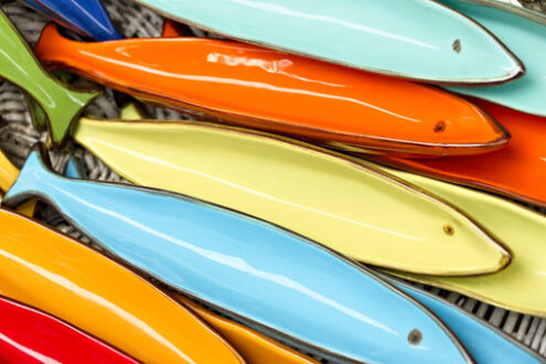 Colorful fish. Corniglia, Cinque Terre. Handmade ceramic decorations representing colored sea stars - MyVideoimage.com | Foto stock & Video footage