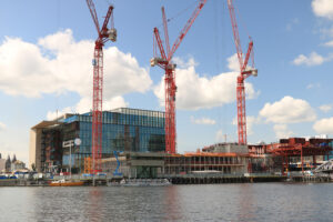 Construction crane in the city center. Blue sky background. Muse - MyVideoimage.com