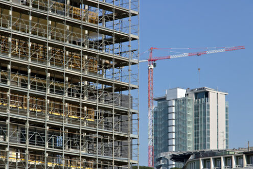 Construction site cranes. Building site for the construction of a modern building. Cantieri edili - MyVideoimage.com | Foto stock & Video footage