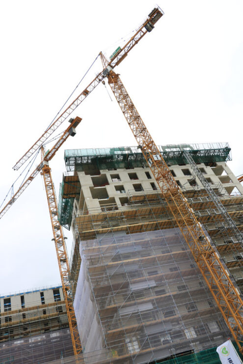 Construction site with cranes in Amsterdam. Construction of a ne - MyVideoimage.com