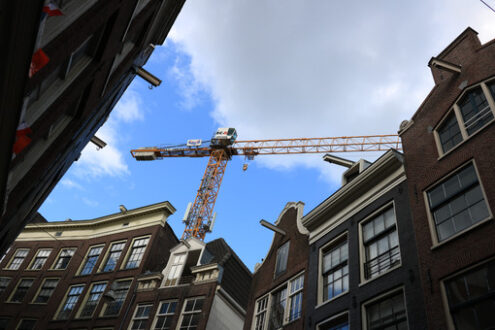 Construction site. Tower crane at a construction site in the historic city center. - MyVideoimage.com | Foto stock & Video footage