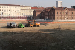 Construction vehicles. Construction site vehicles (trucks, excavators, bulldozers) in a large excavation for the construction of the new building of the Maggiore Policlinico hospital in Milan. - MyVideoimage.com | Foto stock & Video footage